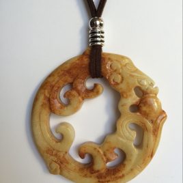331-315 Brown jade pendant. cut on both sides, 80mm diameter, brown suede and silver fronitures